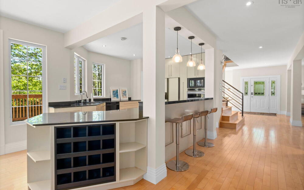 Kitchen with open shelves, black microwave, oven, light wood-style floors, and recessed lighting
