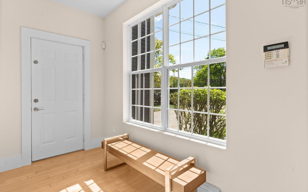 Doorway to outside featuring light wood finished floors and baseboards
