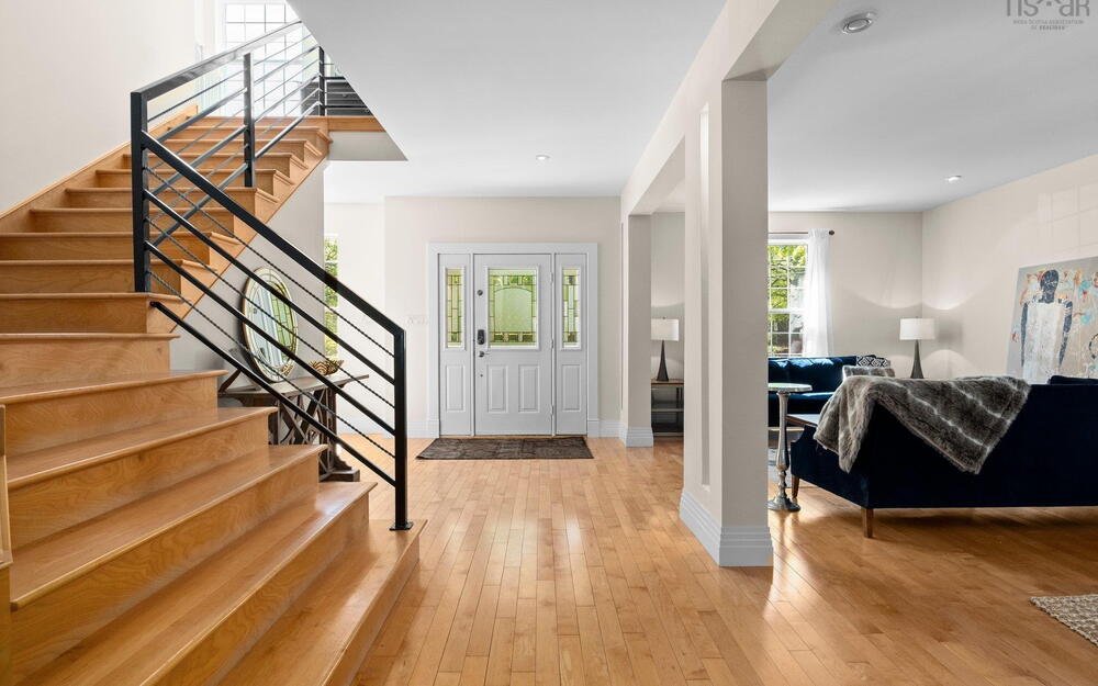 Entryway featuring stairs, light wood-style flooring, and baseboards