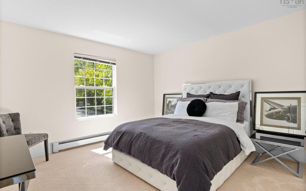 Bedroom with baseboard heating and carpet