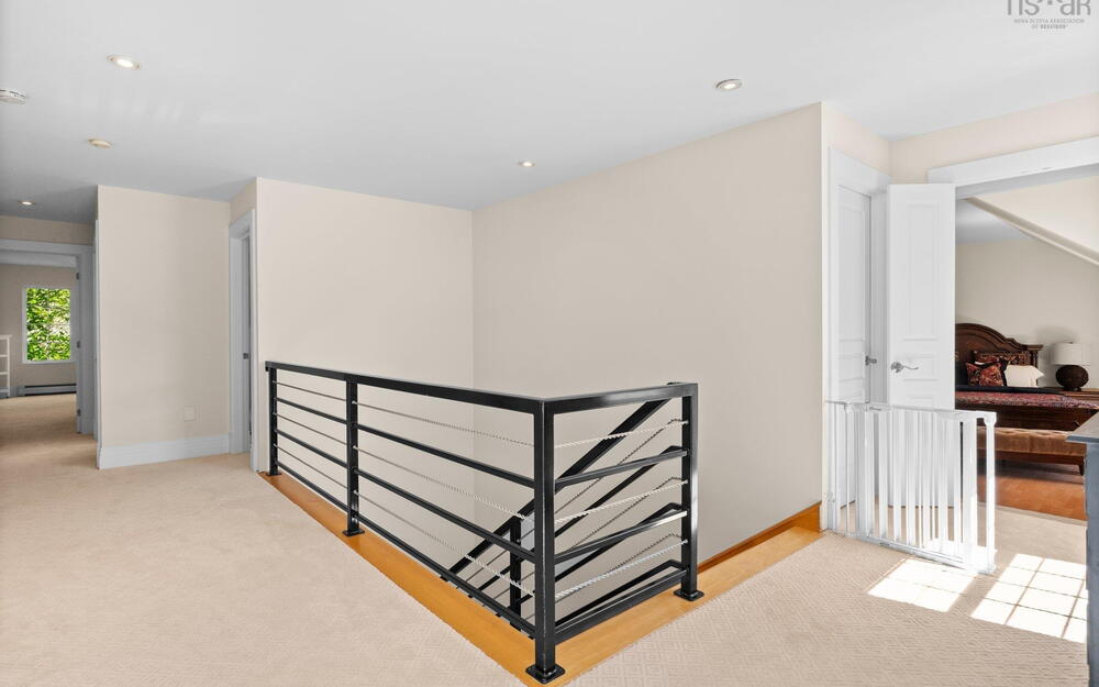 Corridor featuring a baseboard radiator, baseboards, recessed lighting, carpet, and an upstairs landing