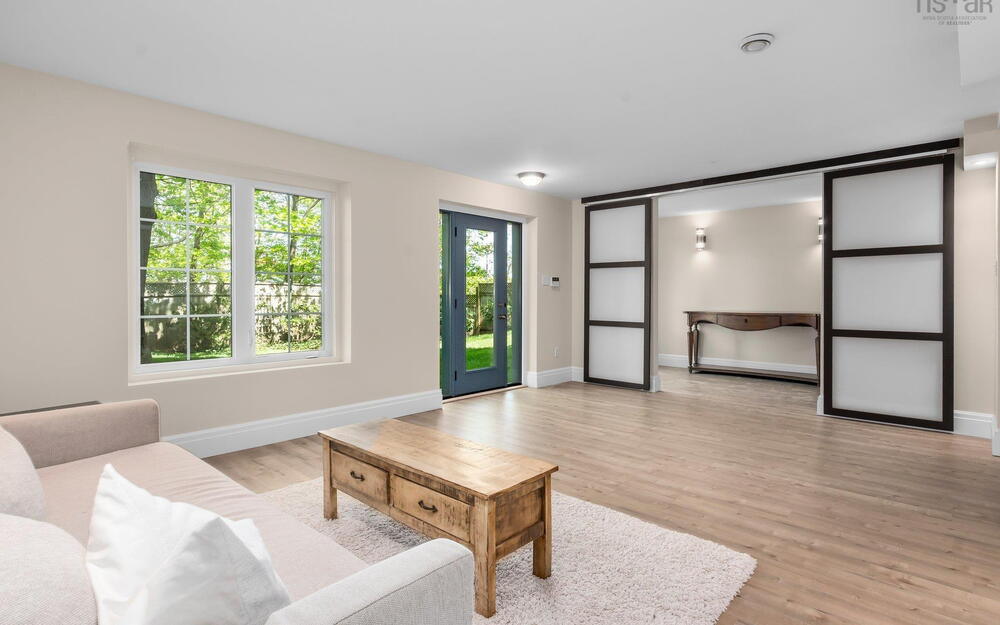 Living area with baseboards and light wood-style flooring