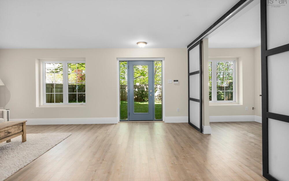 Entryway with plenty of natural light, light wood-style floors, and baseboards