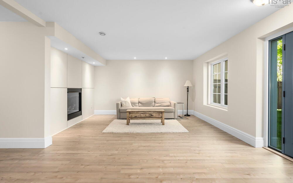 Living area with a large fireplace, light wood-style floors, recessed lighting, and baseboards