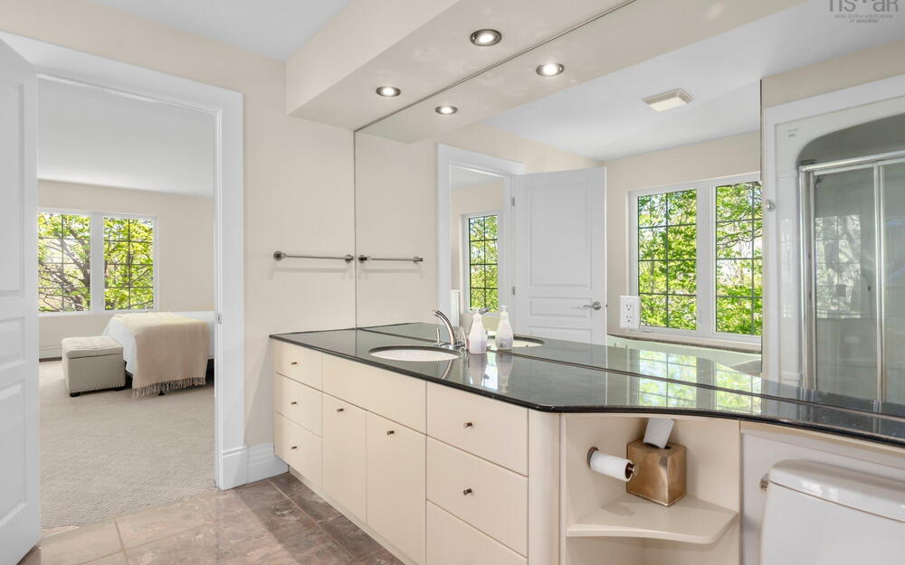 Ensuite bathroom featuring vanity, recessed lighting, and baseboards