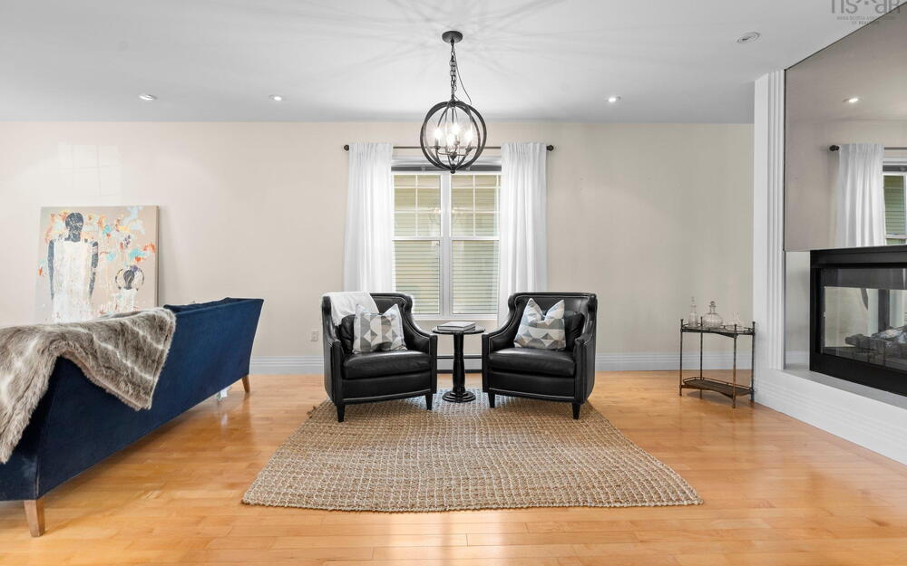 Sitting room with light wood-style flooring, baseboards, recessed lighting, a chandelier, and a baseboard radiator