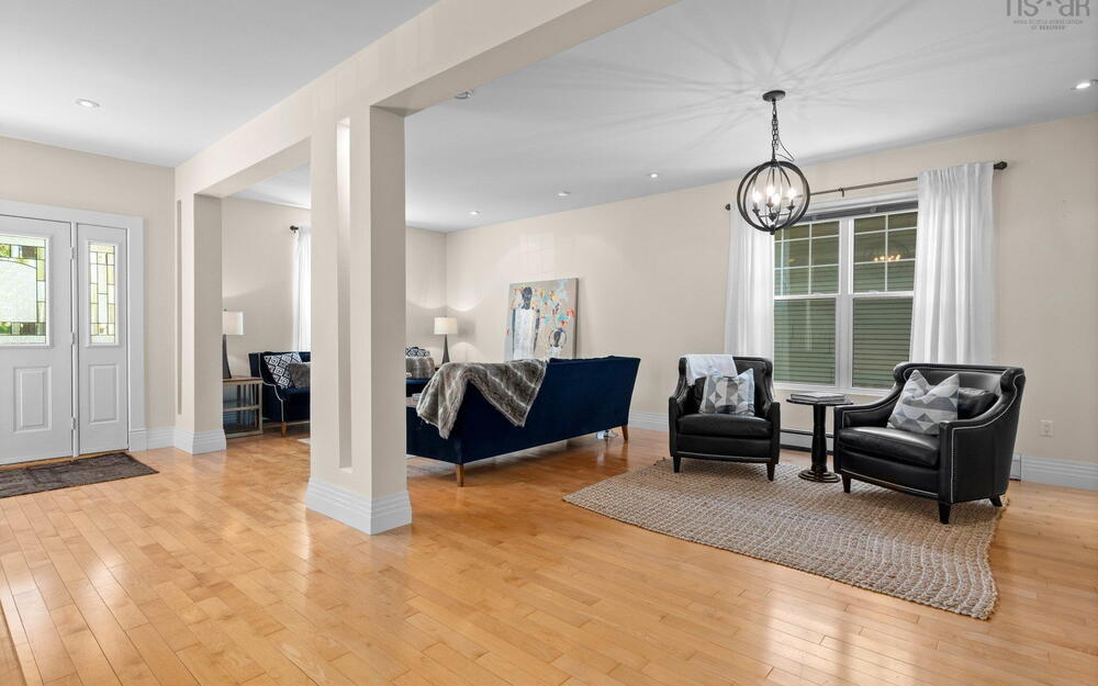 Sitting room featuring light wood-type flooring, a chandelier, baseboards, and recessed lighting