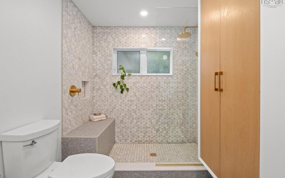 Bathroom featuring toilet and a tile shower