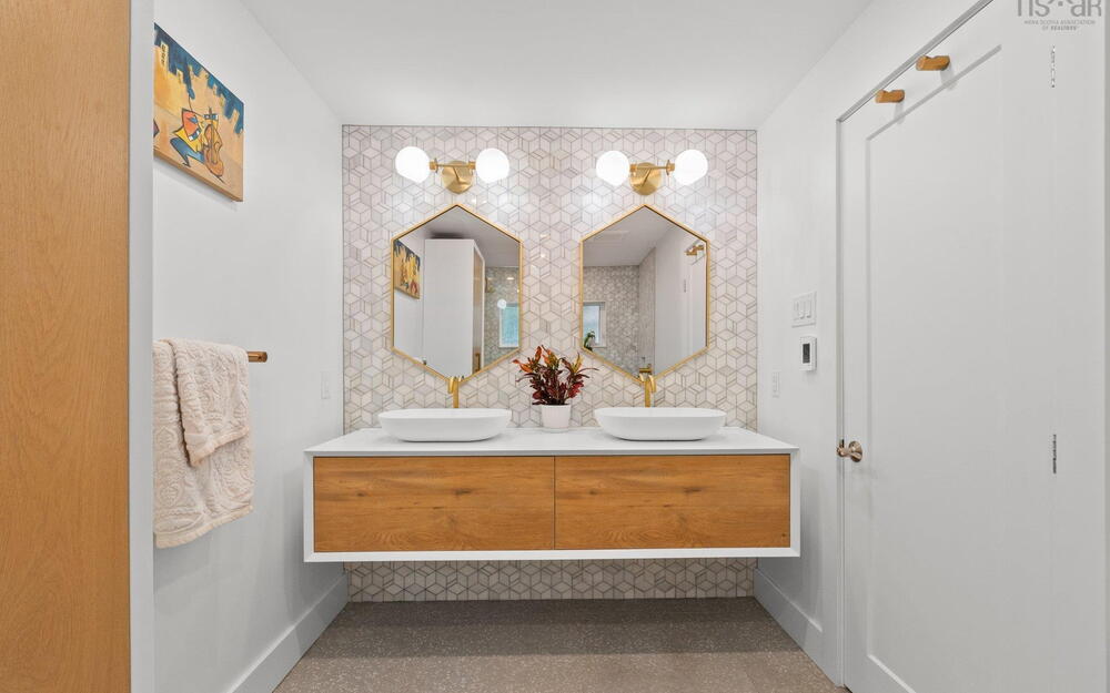 Bathroom featuring double vanity and baseboards
