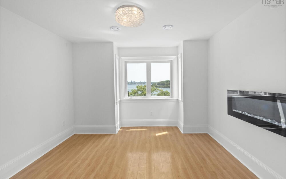 Spare room featuring light wood-style flooring and a water view