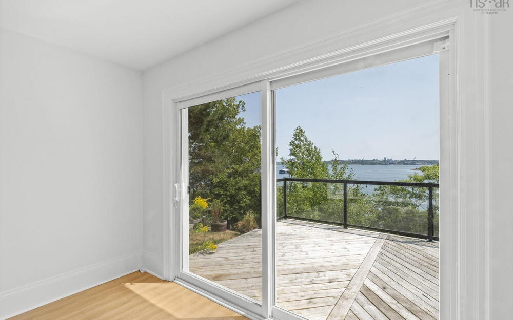 Doorway with wood finished floors and a water view
