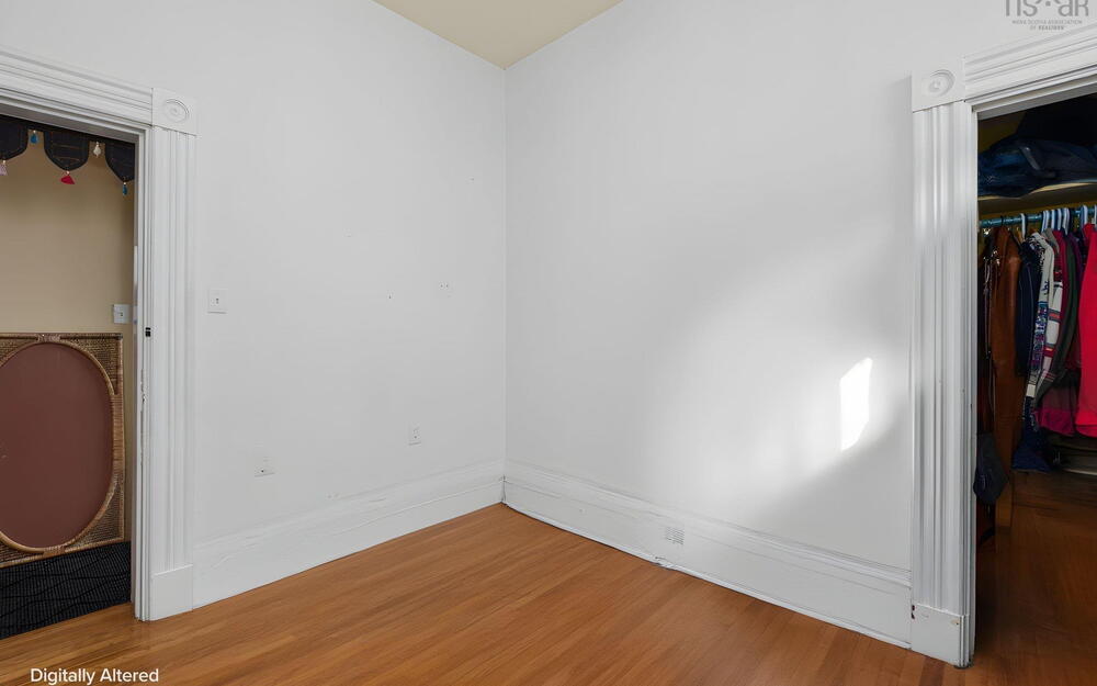 Wood-finish flooring featuring historic door casings with decorative rosettes